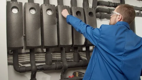 Young engineer checking pressure gauges Stock Footage 127178814
