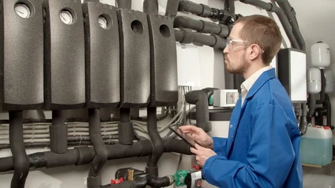 Young engineer checking pressure gauges Stock Footage 127179754
