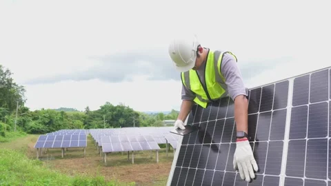 A young engineer checking with a tablet the field of photovoltaic solar panels. Stock Footage 210818502
