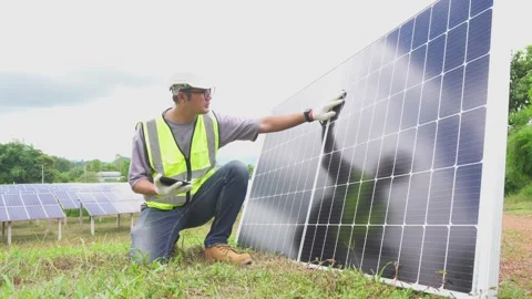 Young engineer checking with a tablet the field of photovoltaic solar panels. Stock Footage 210818695