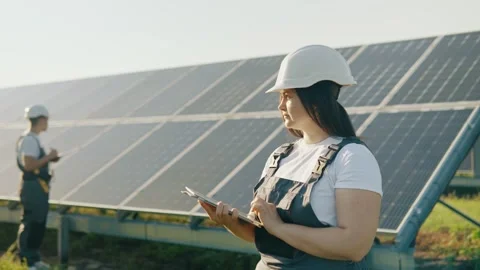 A young engineer checks the operation of solar panels using a tablet Stock Footage 251485174