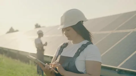 A young engineer checks the operation of solar panels using a tablet Stock Footage 251562604