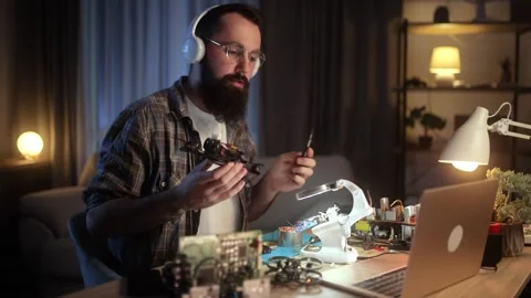 The young engineer is creating a video blog where he teaches the basics of Stock Footage 276426655