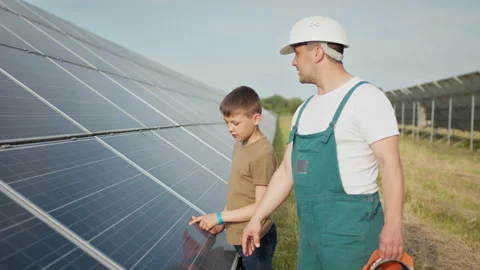 An young engineer father is explaining to his little son an operation and Stock Footage 158821514