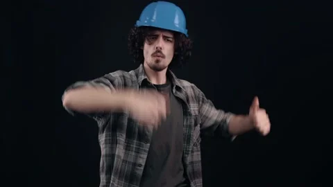 The young engineer, happy, charismatic, dances with his blue helmet. Isolated on Stock Footage 155843704