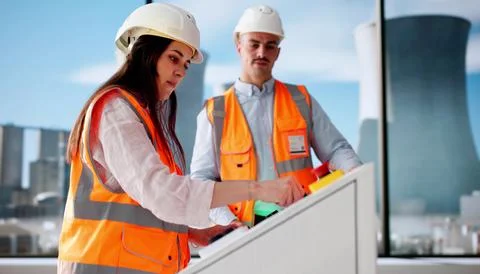 Young Engineer Learning About Power Plant Machines For New Job. Stock Photos
