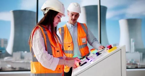 Young Engineer Learning To Operate Machines At Power Plant Station. Stock Photos