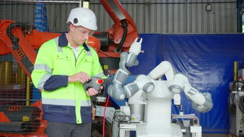 Young engineer man checking and maintenance machine robot arms technology i.. 動画素材 235540321