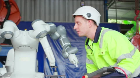 Young engineer man checking and maintenance machine robot arms technology i.. Stock Footage 239252332