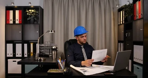 Young Engineer Man Working Calculating Documents Data Using Calculator in Office Stock Footage 80078359