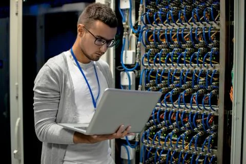 Young Engineer Managing Supercomputer Servers 스톡 사진