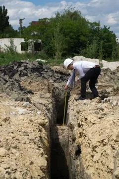 Young engineer measuring on site 스톡 사진