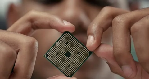 Young engineer in a office, holds in hand and checks the microprocessor Vídeo Stock 283628317