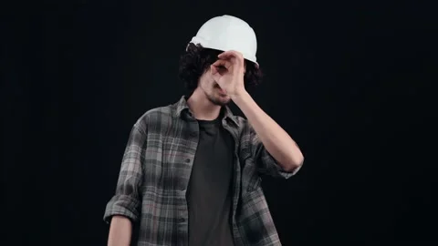 The young engineer, optimistic, with a white helmet, shows the ok sign with his Stock Footage 155632435