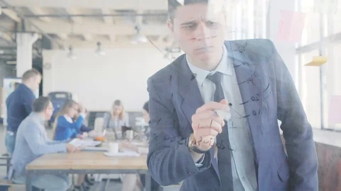 A young engineer prepares a presentation and draws graphics on a glass Stock Footage 109564452
