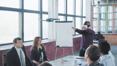 A young engineer remotely controls the drone with hand gestures and virtual Stock Footage 108186499