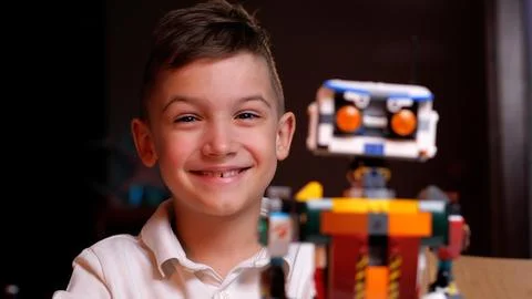 Young engineer smiling with his creation robot from constructor toy 写真素材