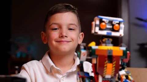 Young engineer smiling with his robot creation Foto stock