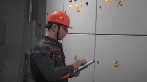 A young engineer is in a technical room. at the factory Stock Footage 105606840