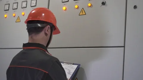 A young engineer is in a technical room. at the factory Stock Footage 105606888