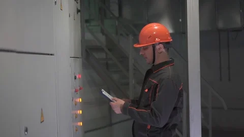 A young engineer is in a technical room. at the factory Stock Footage 105606902