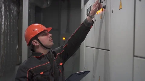 A young engineer is in a technical room. at the factory Stock Footage 105606905