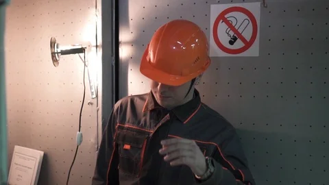 A young engineer is in a technical room. at the factory. no smoke Stock Footage 105607017