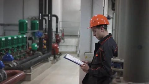 A young engineer is in a technical room. at the factory Stock Footage 105607071