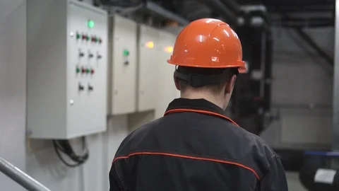 A young engineer is in a technical room. at the factory Stock Footage 105607100