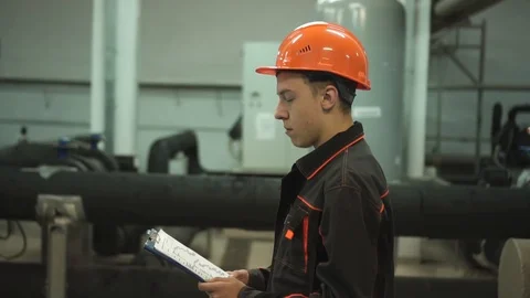 A young engineer is in a technical room. at the factory Stock Footage 105607101