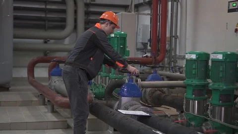 A young engineer is in a technical room. at the factory Stock Footage 105607155