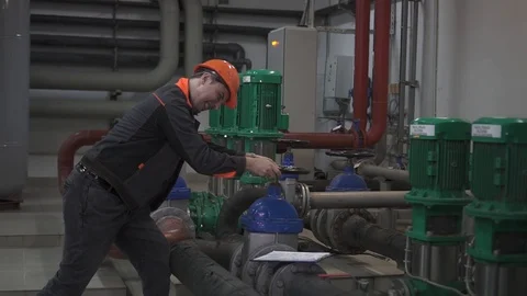 A young engineer is in a technical room. at the factory Stock Footage 105607158