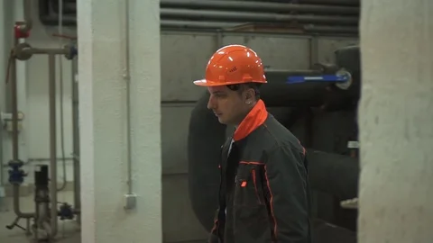 A young engineer is in a technical room. at the factory Stock Footage 105607203