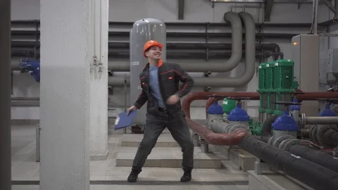 A young engineer is in a technical room. at the factory Stock Footage 105607205