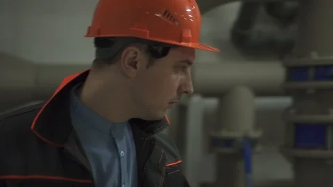 A young engineer is in a technical room. at the factory Stock Footage 105607264