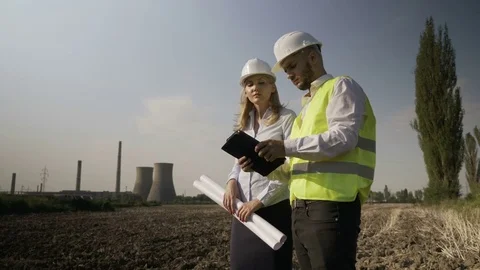 Young engineer technician offering helpful assistance to female architect wit Stock Footage 82177856