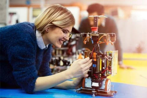 Young engineer testing her robot in workshop 스톡 사진