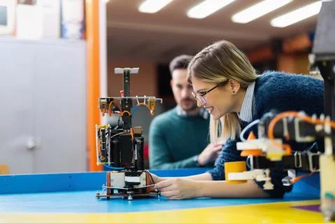 Young engineer testing her robot in workshop 스톡 사진