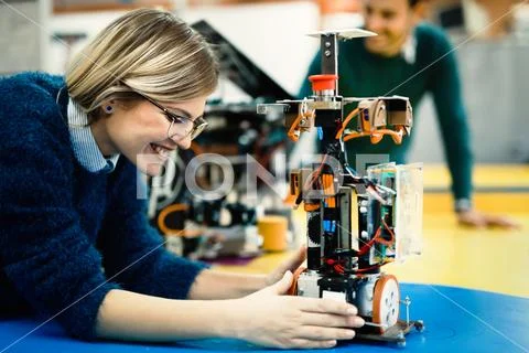 Young engineer testing her robot in workshop 写真素材