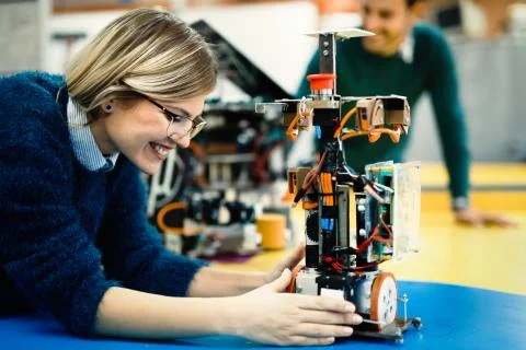 Young engineer testing her robot in workshop 스톡 사진
