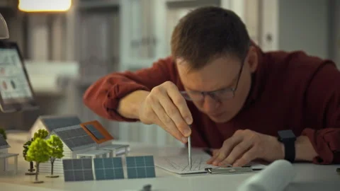 A young engineer wearing glasses conducts research into solar energy. Solar Stock Footage 323725121