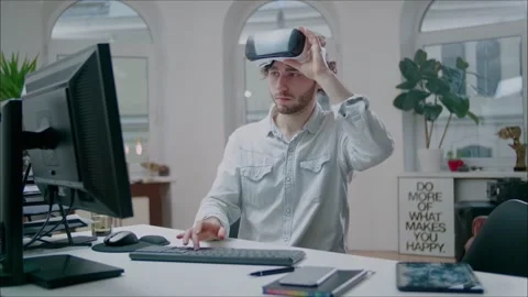 Young Engineer Wearing VR Headset Designs Engine at Modern Office. Stockbeeldmateriaal 134000161