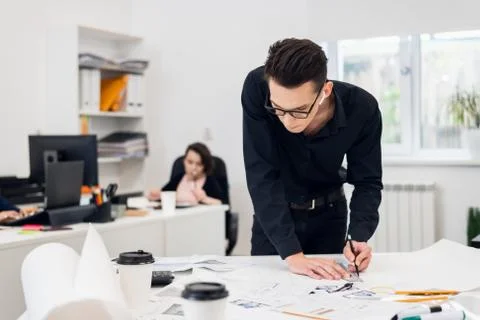 Young engineer at work, creating construction models and making Stock Photos