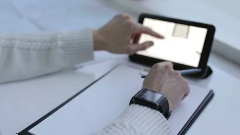 A young engineer works with a smart clock and on a tablet Stock Footage 76552182