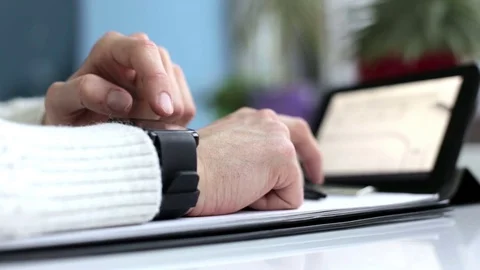 A young engineer works with a smart clock and on a tablet Stock Footage 76866663