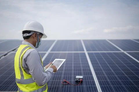 Young engineering working in the power station solar panel Stock Photos