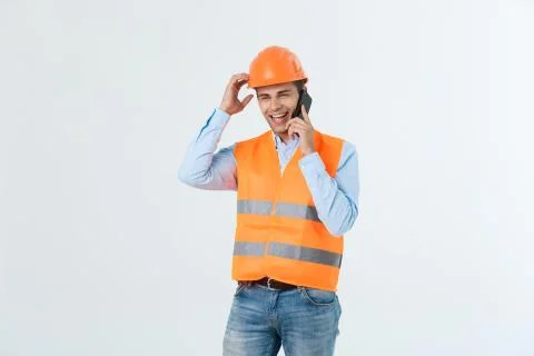 Young engineers are talking mobile phone clear front site to make the building Fotos de archivo