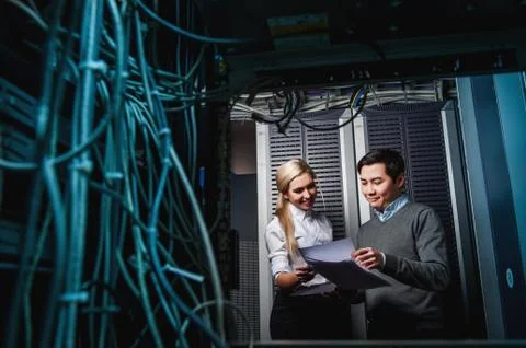 Young engineers businessmen in server room Stock Photos