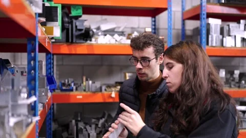 Young engineers checking the stock of a cnc factory Stock Footage 262803192