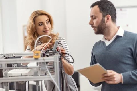 Young engineers installing updates on 3D printer Stock Photos